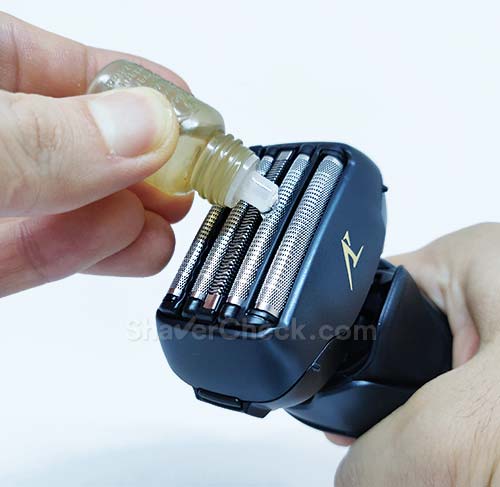 Lubricating the shaver with oil.