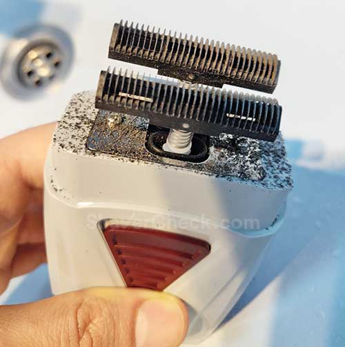 Cleaning the inner blades of the shaver.