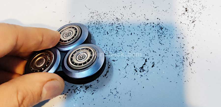 Tapping out the hairs trapped inside the shaving unit of the Shaver 6800.