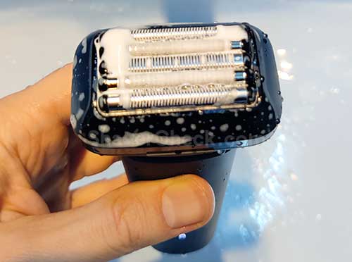 Cleaning the shaver with soap.