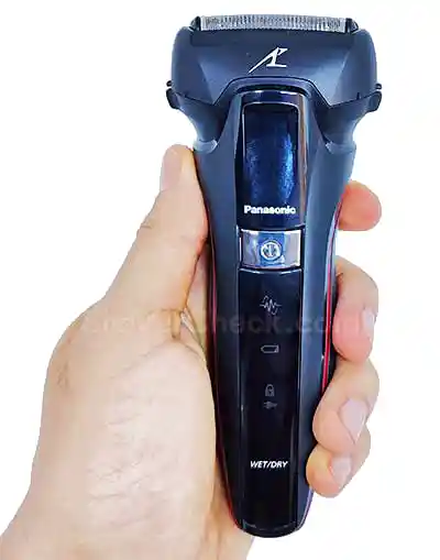 A running Panasonic shaver held in hand.